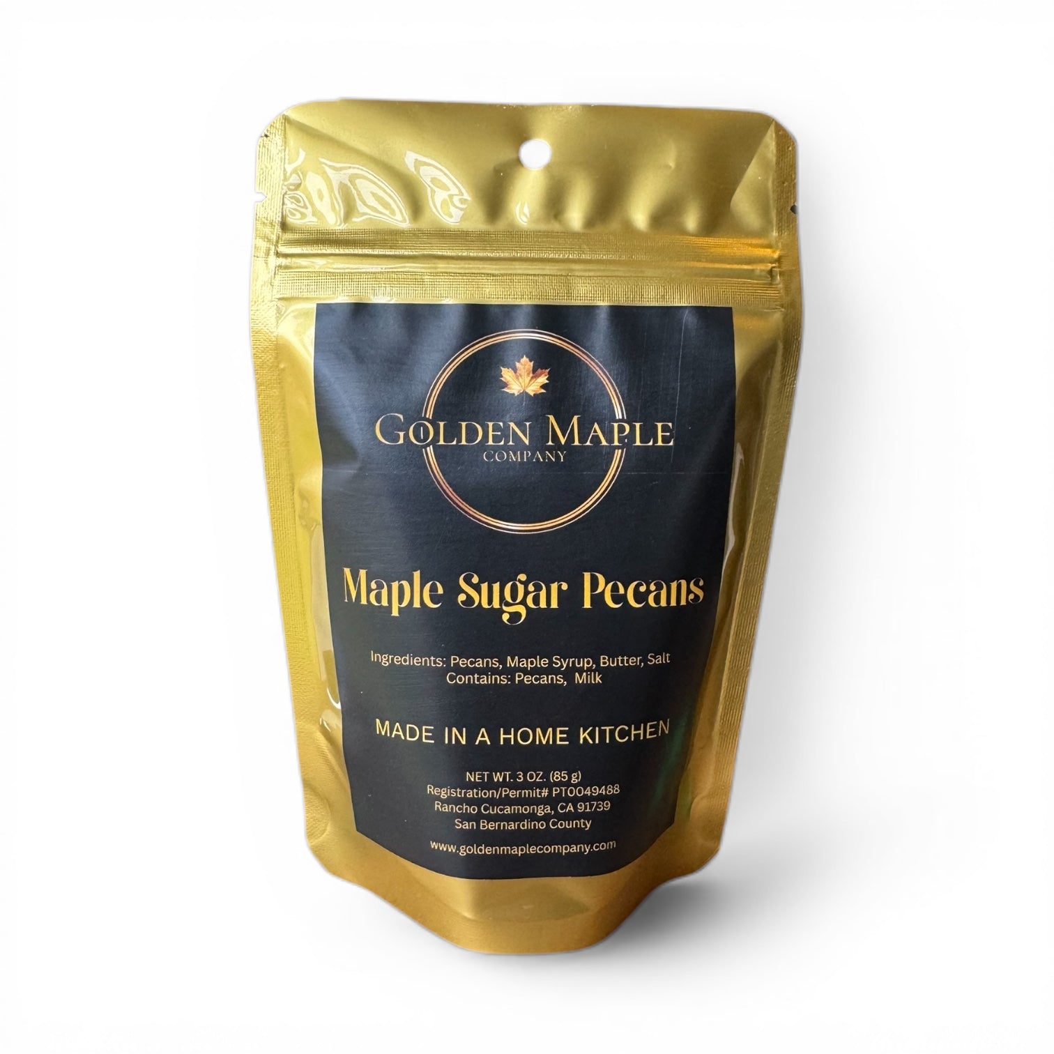 Gold packaging of Golden Maple Company Maple Sugar Pecans on a white background